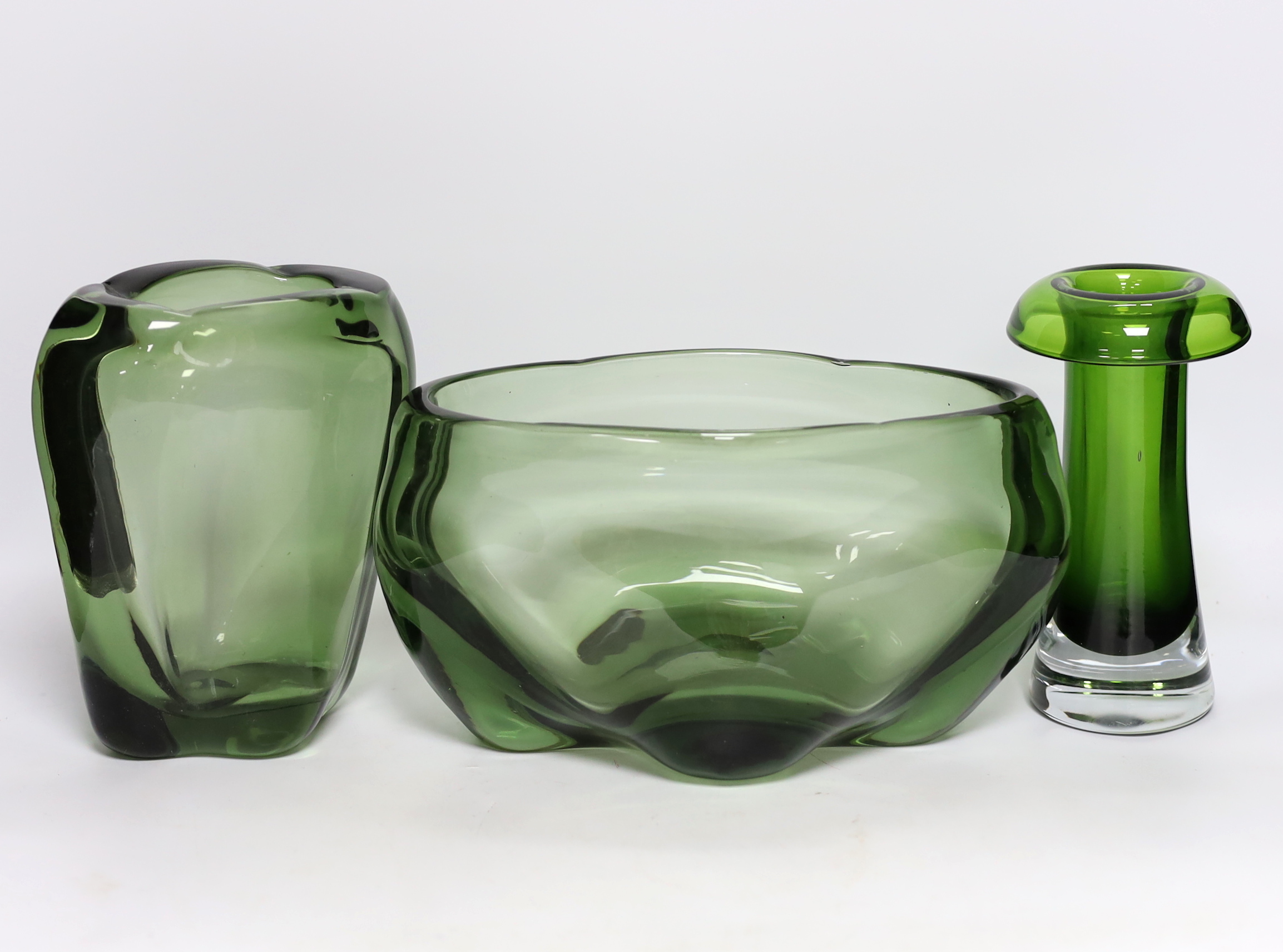 Two Whitefriars green glass vases, designed by James Hogan, and one other, largest 27cm wide